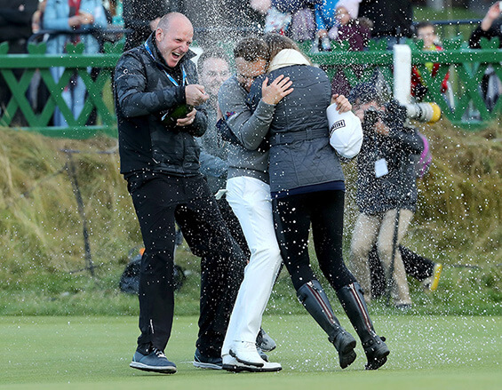 ST ANDREWS, SCOTLAND - OCTOBER 09: Tyrrell Hatton of England is showered by champagne on the 18th green after winning the Alfred Dunhill Links Championship at The Old Course on October 9, 2016 in St Andrews, Scotland. (Photo by David Cannon/Getty Images)